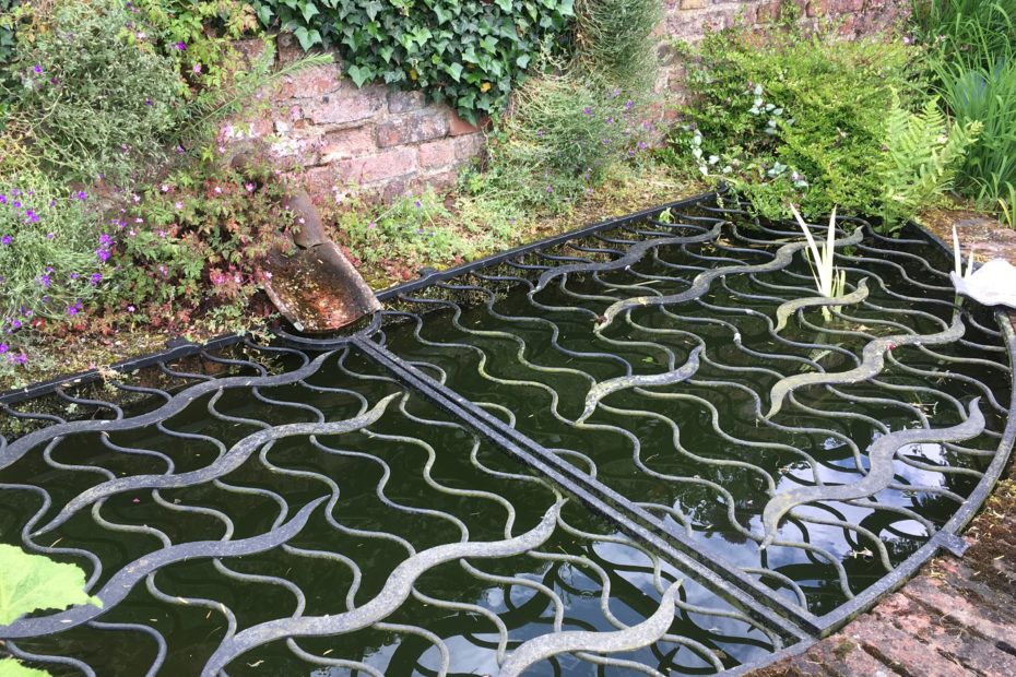 Ornate pond cover to keep the heron out and children safe