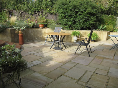 We enlarged the terrace and relaid it with Indian sandstone.  All the walls were rendered which united both the old walls and the new building work.