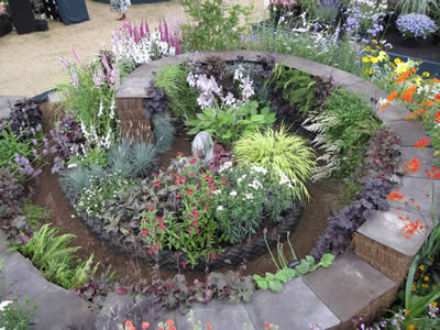 This is our Hopleys gold medal stand in the floral marquee at Hampton Court 2009.  The spiral path is flanked by a living wall.
