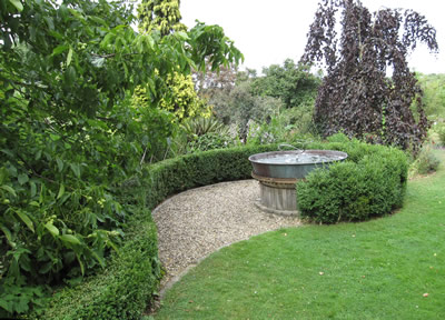 A spiral of box hedging cures around a crucible water feature in my garden.  The spiral is mirroring the spiral pattern created by the water spary in the fountain.