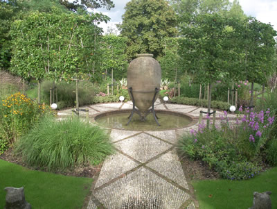 Formal water feature with rills and cobble path.